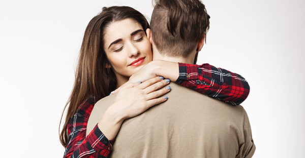 Man standing backside woman friend hugging him romantic mood
