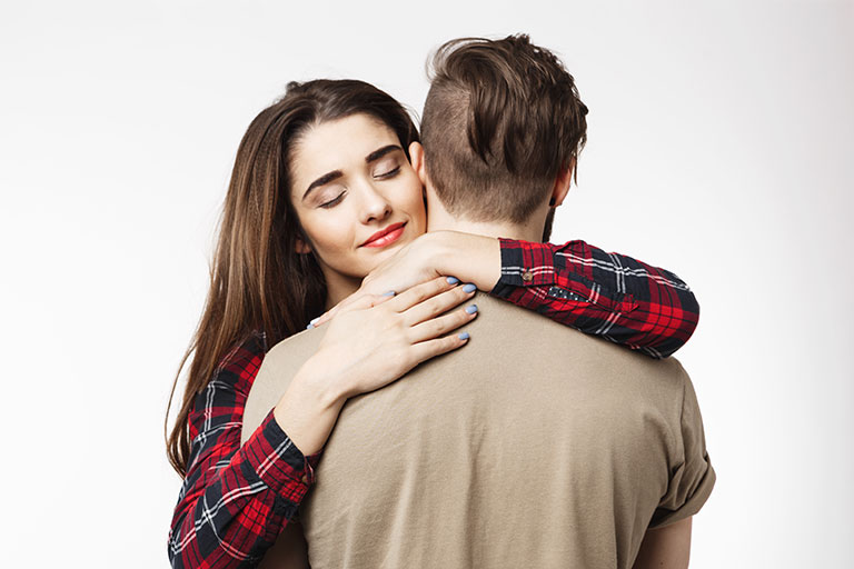 Man standing backside woman friend hugging him romantic mood