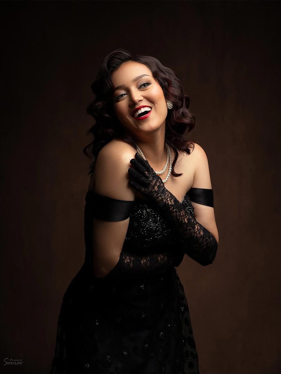 Nabina Ranabhat smiling in studio photoshoot in fashionable outfit.