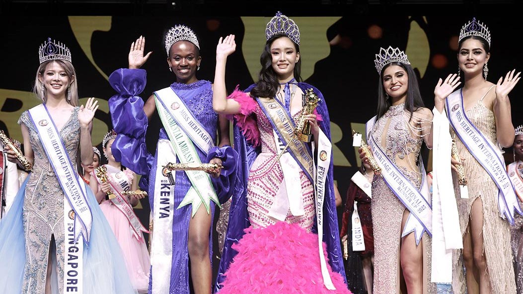 Group photo of Miss Heritage International 2025 titleholders on stage in Bangkok.