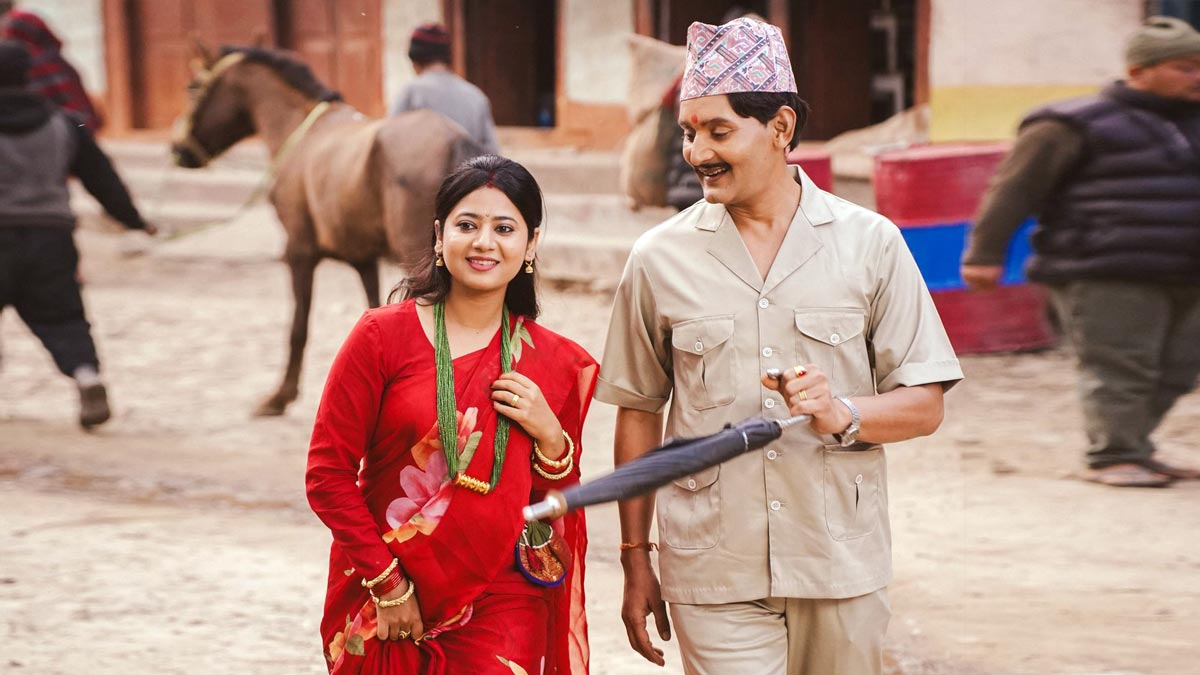 Bipin Karki and Keki Adhikari walk through a quiet village setting in Kaji, capturing a tender moment of married life.