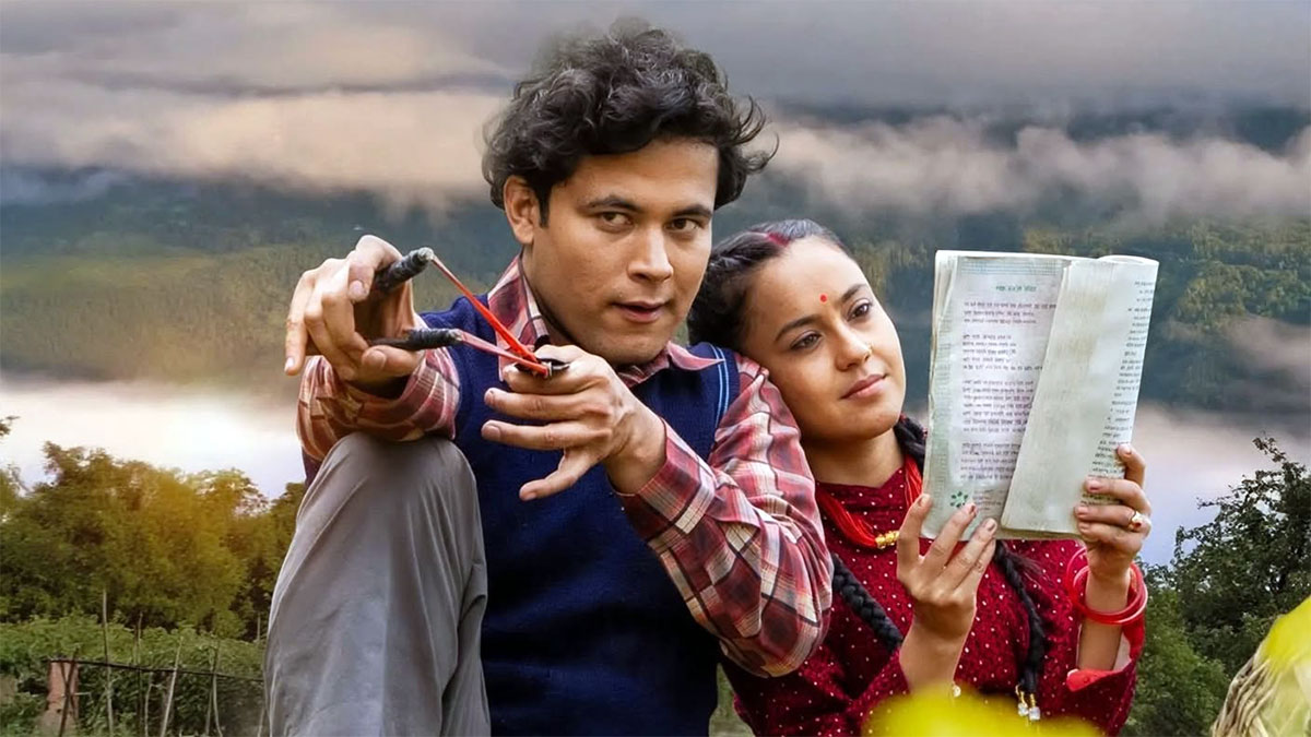 Arun Chhetri aims a slingshot while Simran Khadka holds an open book beside him in a Gauthali film still, with misty hills behind them.