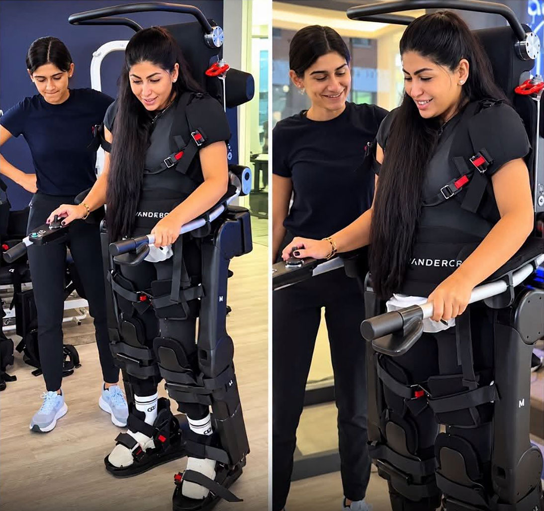 Jessica Tawil standing with support from a wearable robotic exoskeleton.